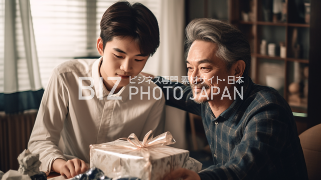 50代の男性と10代の男性が一緒にワクワクしながらプレゼントの包装紙を開ける光景